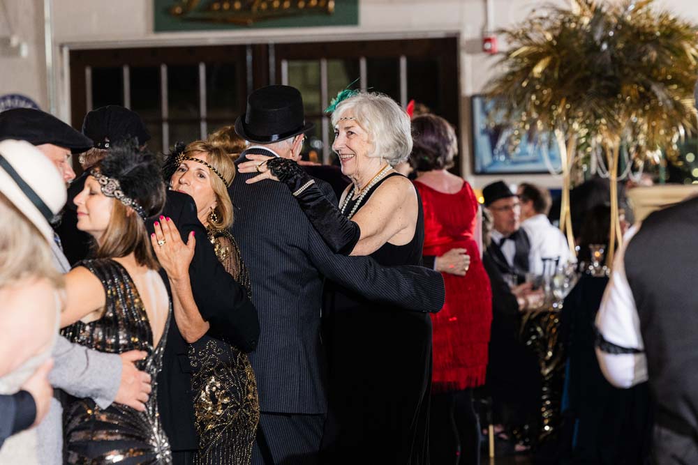 Guests attending the Great Gatsby Gala fundraiser at the Packard Proving Grounds